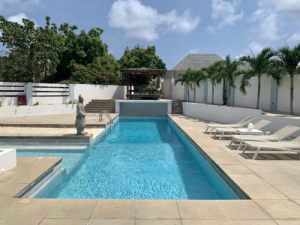The real estate agency of Curacao offers: Fantastic family home with large pool for sale on gated Jan Sofat Curacao,  Willemstad